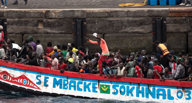 African migrant people part of a group of 242 migrants onboard of two boats arrive onboard a cayu