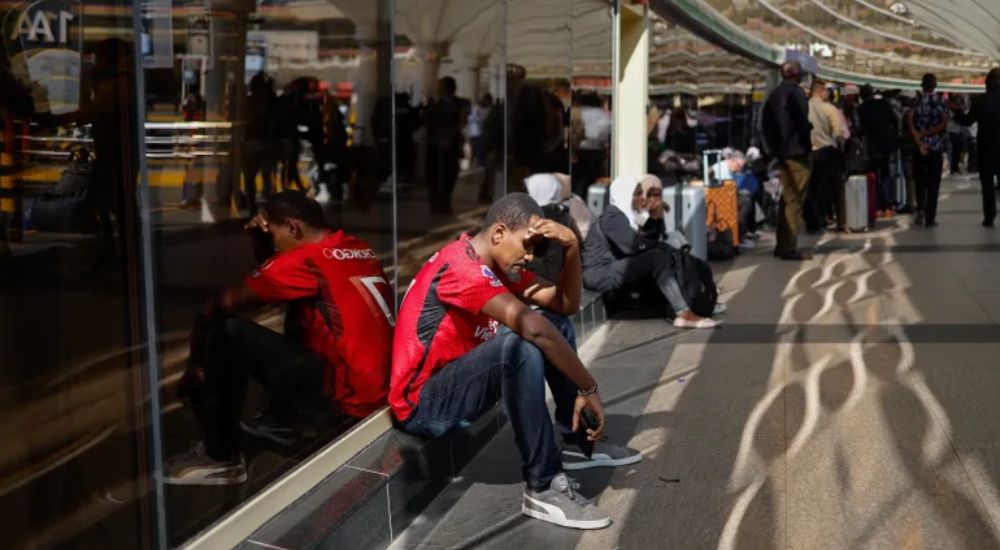 Passengers wait at a closed door at the departures terminal of the Jomo Kenyatta International Airpo