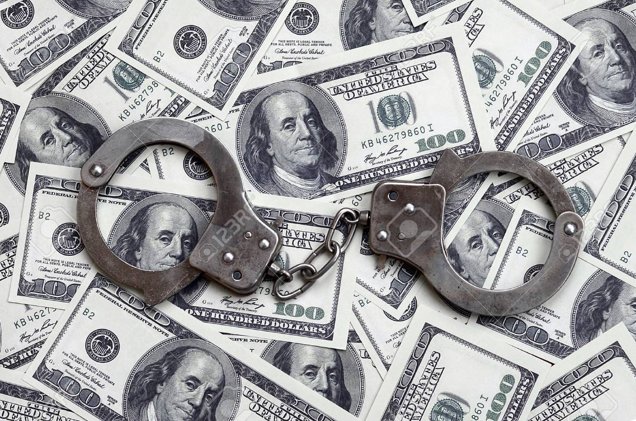 90764349 police handcuffs lie on a lot of dollar bills the concept of illegal possession of money il