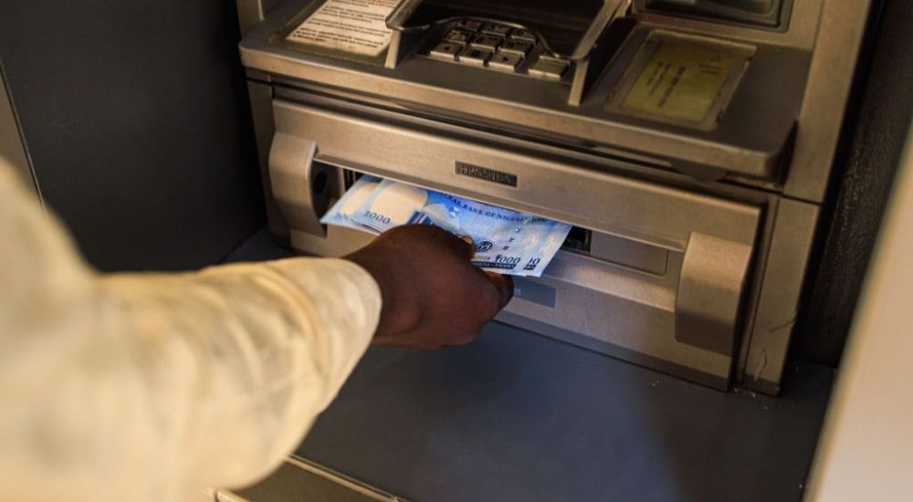 A customer withdraws from an automated teller machine ATM