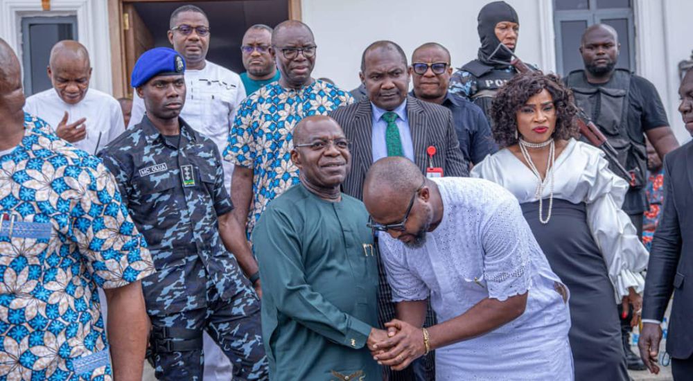 Governor Otti with the bereaved Stanley Egege at the funeral service