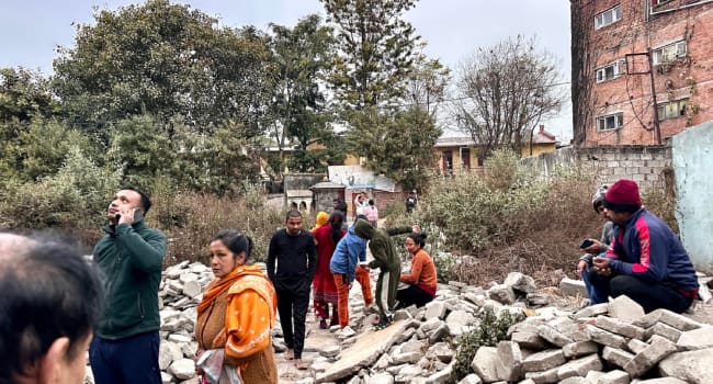 People gather in an open area following earthquake tremors in Kathmandu in the early hours on Janua