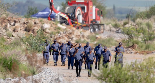 South African Police Service SAPS officers walk near a Metalliferous Mobile Rescue Winder during a.j