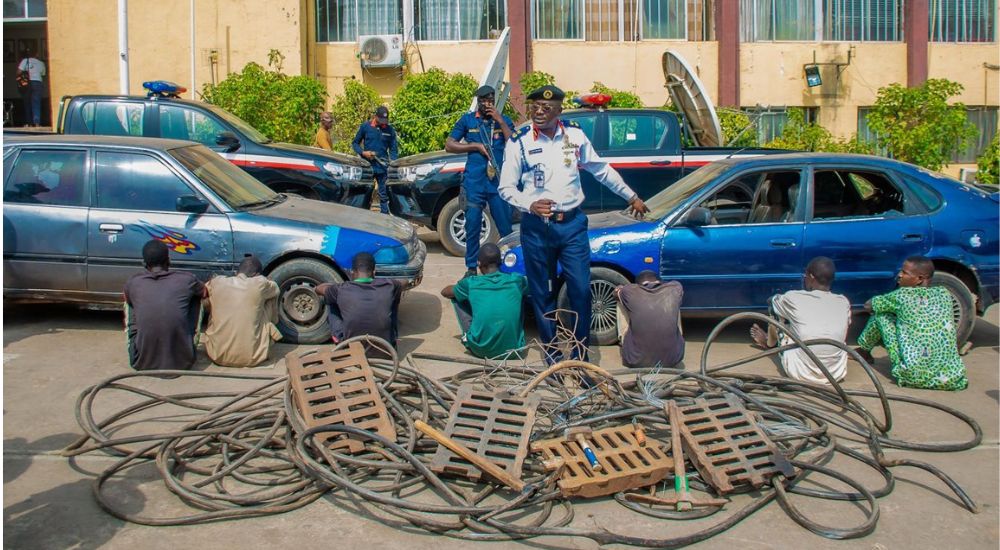 The FCT NSCDC Commandant Dr. Olusola Odumosu in the midst of suspected vandals and items recovered.j