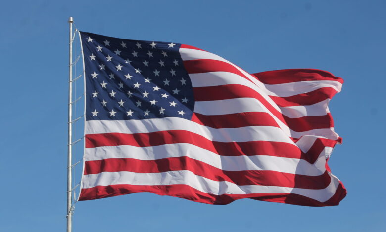 American Flag Waving on a Flag Pole scaled