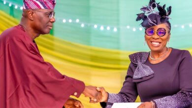 Bola Okikiolu Ighile in a handshake with Governor Sanwo Olu 1200x630