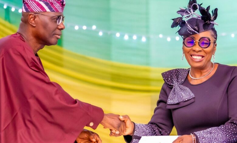 Bola Okikiolu Ighile in a handshake with Governor Sanwo Olu 1200x630