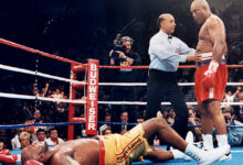 George Foreman standing over Michael Moorer at his comeback match for the world heavyweight title on