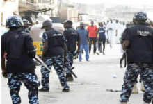 Policemen at a crime scene on cult clash