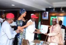 Nicholas Ukachukwu receiving the certificate of return from Ganduje 953x630