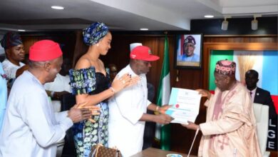 Nicholas Ukachukwu receiving the certificate of return from Ganduje 953x630